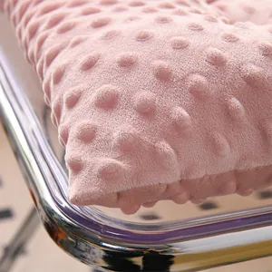 Close-up detail of soft pink minky dot fabric texture on a thickened seat cushion.
