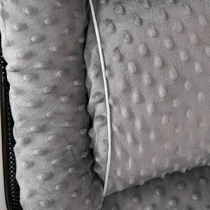 Macro detail of grey minky dot fabric cushion with soft raised texture