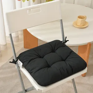 Detail view of a premium thick black tufted fabric chair cushion with tie-on straps
