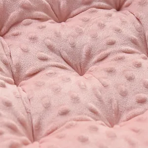 Close-up detail of soft pink minky dot fabric texture on a thick seat cushion.