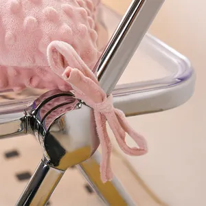 Close-up of pink minky dot chair cushion tie strap on a metal frame
