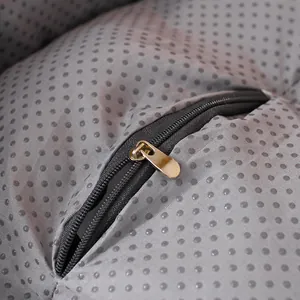 Macro detail of the high-quality zipper and non-slip bottom on a grey seat cushion