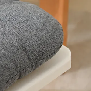 Close-up of a grey fabric chair cushion showing detailed woven texture and edge stitching