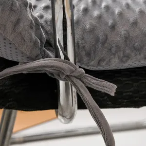 Close-up detail of gray dotted minky plush chair cushion with secure tie and textured fabric