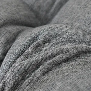 Close-up macro detail of grey linen-like fabric texture on a comfortable thickened seat cushion