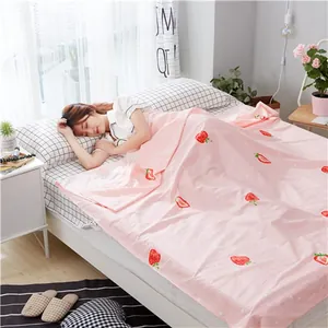 Asian woman sleeping comfortably with strawberry print cotton travel sheet liner