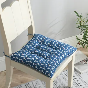 Vista detallada de un cojín de silla azul de algodón y lino con patrón de ganso blanco