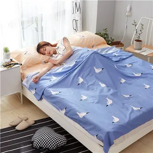 Close-up detail of soft cotton travel sleeping bag liner with blue seagull pattern