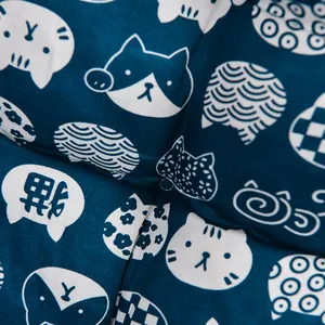 Macro detail of blue brushed fabric chair cushion featuring cute white cat patterns