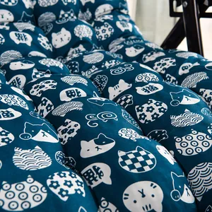 Macro detail of navy chair cushion with cute cat pattern and soft quilted texture