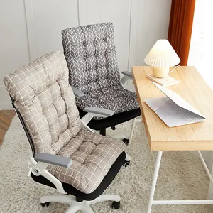 Detailed view of thick quilted chair cushions with grid and chevron patterns in an office.