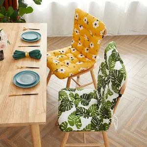 Thick integrated chair cushions with floral and leaf patterns in a dining setting
