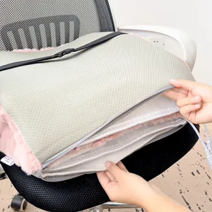 Close-up detail of electric heated seat cushion with zipper and soft plush lining