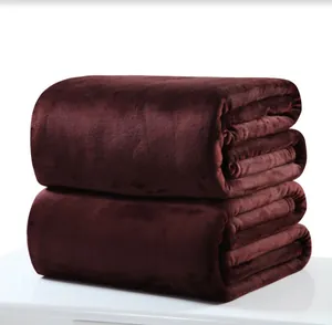 Close-up view showing the soft plush texture of stacked burgundy flannel blankets