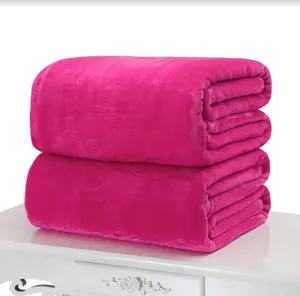Close-up of fuchsia flannel blankets stacked neatly on a white ornate table
