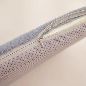 Close-up of the zipper and non-slip bottom texture on a plush heated seat cushion