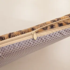 Close-up of zipper and anti-slip bottom on leopard print plush heated seat cushion