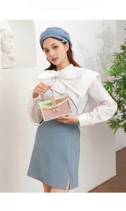 Iridescent transparent crossbody bag with pink quilted inner pouch held by model