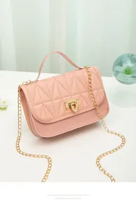 Detail of pink quilted PU leather handbag with gold chain strap and stylish hardware latch