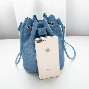 Minimalist blue lychee texture drawstring bucket bag with adjustable shoulder strap