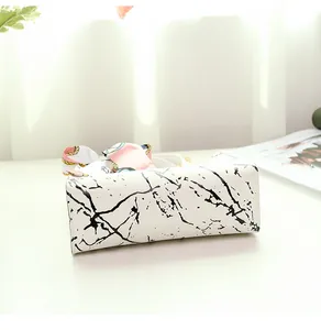 Detailed bottom view of stylish white marble pattern handbag with decorative silk scarf