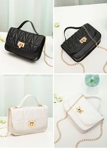Quilted chain crossbody bag in black and white with metal lock detail.