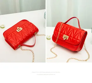 Quilted red PU leather crossbody bag with gold chain strap and lock.