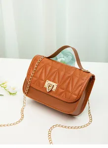 Detailed view of the tan quilted flap bag featuring a gold chain strap and lock
