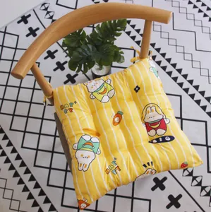 Vista detallada del cojín de silla cuadrado amarillo con estampado de conejo y acolchado