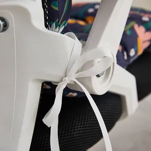 Macro view showing the white ribbon tie-on system for the floral office seat cushion.