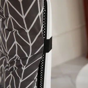 Detail showing the elastic fixing strap and gray herringbone pattern of the chair cushion