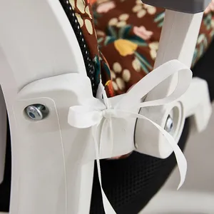 Close-up of white ribbon tie-on detail for floral chair cushion with thick padding