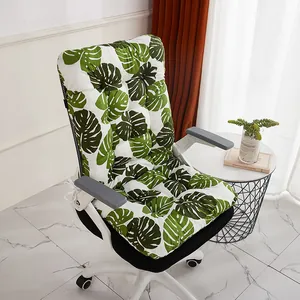 High-angle detail of a thick office chair cushion with green monstera leaf print.