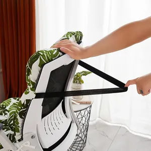 Detail showing the elastic back strap securing the green leaf pattern chair cushion
