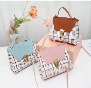 Group of three small plaid crossbody handbags in pastel colors with metal clasp