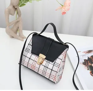 Stylish black and white plaid crossbody bag with gold lock buckle and top handle