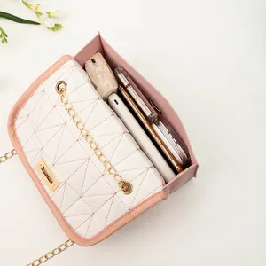 Fashionable embroidered chain crossbody bag with gold lock showing spacious internal storage