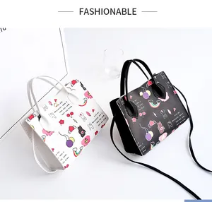 Stylish cartoon print handbags in black and white featuring top handles and crossbody straps