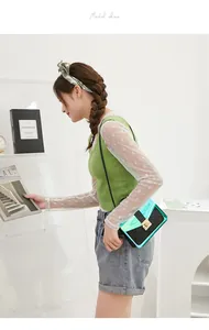 Lifestyle view of trendy holographic green and black quilted crossbody bag with clasp