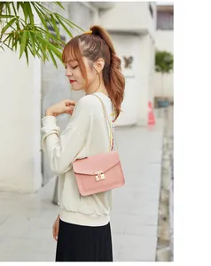 Asian model wearing a stylish pink chain strap crossbody bag in a lifestyle setting
