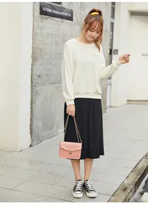 Elegant pink crossbody chain bag for women with gold lock buckle shown on model