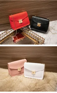 Detailed view of lizard skin texture chain crossbody bag with elegant gold lock closure