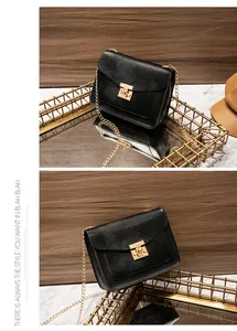 Detailed views of elegant black lizard-pattern bag with gold chain and lock closure