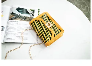 Fashionable yellow and black houndstooth pattern crossbody bag with gold-tone lock detail