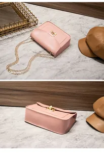 High-quality detail of an elegant pink small square crossbody bag with gold chain