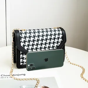 Stylish black and white houndstooth pattern small square crossbody bag with gold chain strap