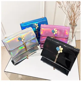 Close-up detail of stylish iridescent laser flap bags featuring elegant flower tassel hardware