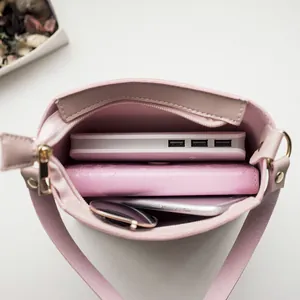 Minimalist pink leather shoulder bag showing internal storage capacity