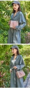Detailed view of a stylish plaid color-block small square crossbody bag outdoors