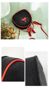 Close-up of lychee pattern leather and neat red edge stitching on the crossbody bag